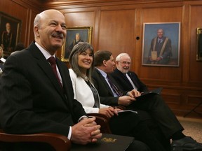 Reza Moridi, Ontario’s minister of research, innovation and science, left, sits with, from left, Kingston and the Islands MPP Sophie Kiwala, Queen’s University principal Daniel Woolf, and Nobel Prize laureate Arthur McDonald at the announcement of $77 million in provincial funding for research across Ontario, including $4.5 million for four researchers at Queen’s University on Tuesday. (Elliot Ferguson/The Whig-Standard)
