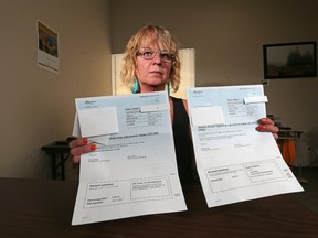 Darlene Piche holds the carbon tax rebate her mom received along with the bill for it's return after she passed away this past January. At least three Alberta families say they've been issued bills from the province to return carbon tax rebates after loved ones died. Piche was photographed in Strathmore on Tuesday March 14, 2017. GAVIN YOUNG/POSTMEDIA NETWORK