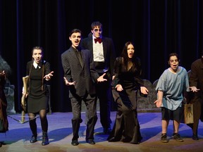 From left, Mya Soleil Matos, as Grandma, Sydney Harvey is Wednesday, Preston Cooper-Winder is Gomez, Matthew Van Bussel is Lurch, Kathleen Bialik portrays Morticia, Tanner Hamlin is Pugsley and Connor Englert is Uncle Fester, in the London Youth Theatre Education production of the Addams Family at the Palace Theatre. (MORRIS LAMONT, The London Free Press)