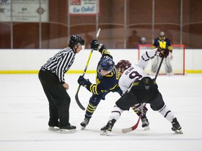 Close-quarters action like this can be expected when the NAIT Ooks (Brayden Harris #21) and MacEwan Griffins (Ryan Benn #9) square off in the best-of-three ACAC men’s hockey final starting Friday. These two were involved as MacEwan posted a 4-2 victory, their second in as many games, as they took temporary possession of first place and erased a NAIT undefeated streak that lasted more than a calendar year. (Supplied)