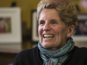 Premier Kathleen Wynne calls hydro customers from her Queen's Park office in Toronto on Friday, March 3, 2017. (Craig Robertson/Toronto Sun)