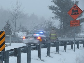 First responders are seen on an on-rampt to highway 401 near Lansdowne, Ont., on Tuesday, March 14, 2017. A crash involving at least 30 vehicles on a major highway east of Toronto caused a chemical spill on Tuesday, prompting police to evacuate the area. THE CANADIAN PRESS/Lars Hagberg