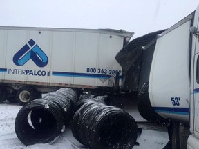 A transport truck rests in a jackknifed position with its cargo spilled at the scene of the March 14th multi-vehicle pileup and chemical spill near Lansdowne. (FILE PHOTO)