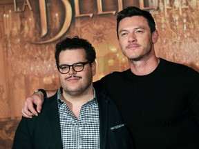 Actor Josh Gad, left, who plays manservant LeFou, and Luke Evans, who plays villain Gaston, pose during a promotional event for the movie "Beauty and the Beast", in Paris Feb. 20, 2017. (AP Photo/Christophe Ena)