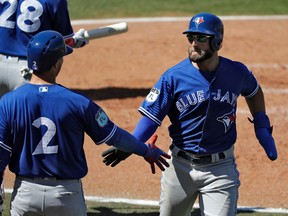 Toronto Blue Jays' Kevin Pillar shakes hands with Troy Tulowitzki after scoring during a spring training game on March 9, 2017. (AP Photo/Chris O'Meara)