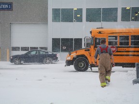 A lone firefighter walks on toward an emergency shelter set up at the Lansdowne fire station after patients were transported from the scene of a multi-vehicle collision and chemical spill on Highway 401 in March 2017. Victims in the crash were decontaminated here and cared for until they could be transported to the hospital. (FILE PHOTO)