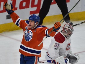 Edmonton Oilers Milan Lucic (27) scores on Montreal Canadiens goalie Carey Price (31) during second period NHL action at Rogers Place in Edmonton, Monday, March 12, 2017.
