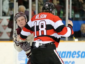 Hudson Wilson of the 67’s and Matt Spencer of the Petes square off during yesterday’s game. (WAYNE CUDDINGTON/Postmedia Network)