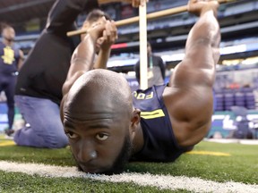Leonard Fournette has a measurement taking during the NFL combine earlier this month. (AP)