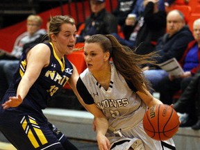 Kaitlyn Verduzco, right, of the GPRC Wolves women's basketball team, tries to power her way around Cassidy Taal, of the NAIT Ooks on Friday January 20, 2017 in Alberta Colleges Athletic Conference action at Grande Prairie Regional College in Grande Prairie, Alta.