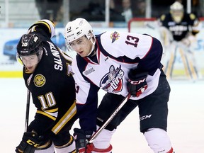 Sarnia Sting's Anthony Salinitri (10) and Windsor Spitfires' Gabriel Vilardi (13) battle for the puck in the first period at Progressive Auto Sales Arena in Sarnia, Ont., on Wednesday, March 15, 2017. (MARK MALONE/Postmedia Network)