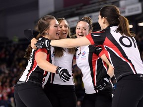 Ontario third Emma Miskew, left to right, skip Rachel Homan, second Joanne Courtney and lead Lisa Weagle celebrate after defeating Manitoba in the gold medal match at the Scotties Tournament of Hearts in St. Catharines, Ont., on Sunday, Feb. 26, 2017. THE CANADIAN PRESS/Sean Kilpatrick