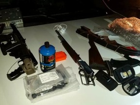 RCMP seized a loaded SKS rifle, a loaded Marlin rifle, ammunition and bow after a man was spotted walking along Highway 625 near Range Road 232 at 3 a.m. March 15, 2017, and arrested by an off duty Edmonton police officer. Supplied EDMONTON