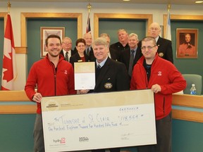 Hydro One conservation analyst Gennaro D'Atri and CLEAResult's Braedyn Stockfish present a rebate cheque in the amount of $118,554.85 to St. Clair Township Mayor Steve Arnold, a result of the township switching its streetlights from traditional bulbs to LED. 
CARL HNATYSHYN/SARNIA THIS WEEK