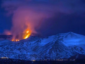 Snow-covered Mount Etna spews lava during an eruption in the early hours of Thursday, March 16, 2017. (AP Photo/Salvatore Allegra)