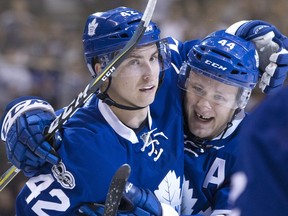 Toronto Maple Leafs' Tyler Bozak, left, celebrates with Morgan Rielly after scoring during second period NHL hockey action against the Philadelphia Flyers, in Toronto on Thursday, March 9, 2017. (Canadian Press)