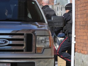 Kingston Police Street Crime unit remove 17 kegs from a house during a pre-St. Patrick's Day raid on Earl Street across Queen's University  in Kingston, Ont. on Thursday March 16, 2017. Steph Crosier/Kingston Whig-Standard/Postmedia Network