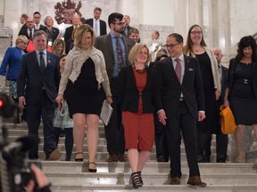 The Alberta Premier Rachel Notley is flanked by Alberta Finance Minister Joe Ceci as they leave the Legislative Chamber and walk down the stairs to the Rotunda on March 16, 2017.