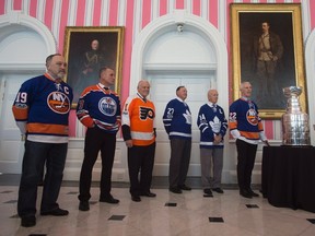 Former NHL players Bryan Trottier, Paul Coffey, Bernie Parent, Frank Mahovlich, Dave Keon and Mike Bossy stand next to the original Stanley Cup and the Stanley Cup trophy during an event at Rideau Hall on March 16, 2017 in Ottawa. (THE CANADIAN PRESS/Adrian Wyld)