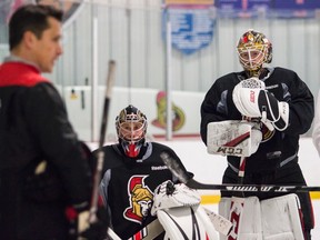 Ottawa Senators goaltenders Craig Anderson and Mike Condon listen to head coach Guy Boucher during team practice at the Sensplex on Nov. 21, 2016. (Errol McGihon/Postmedia)