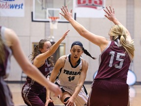 Vincent Massey Trojans guard Niyah Becker (centre) dribbles through a maze of Westwood Warriors last night. Kevin King/Postmedia Network