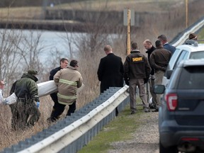 A body is recovered near Silver Lake in Highland, Ill., on Thursday, March 16, 2017, after a car with an infant was pulled from the lake earlier in the morning. (Laurie Skrivan/St. Louis Post-Dispatch via AP)