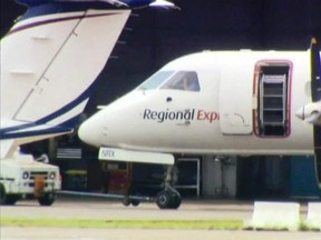 This image made from video shows a passenger plane being moved at Sydney Airport, in Sydney, Australia Friday, March 17, 2017. The plane landed safely Friday after one of its two propellers fell off in an extraordinary emergency as it approached the airport. The Regional Express Airlines crew reported the right engine propeller assembly separated from the Saab 340 airliner 20 kilometers (12 miles) southwest of the airport, Civil Aviation Safety Authority spokesman Peter Gibson said. (Channel 9 via AP)