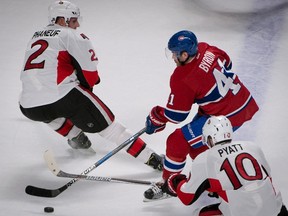 Montreal Canadiens' Paul Byron, centre, squeezes between Ottawa Senators' Dion Phaneuf, left, and Ottawa Senators' Tom Pyatt during first period NHL hockey action in Montreal, Tuesday, November 22, 2016. THE CANADIAN PRESS/Peter McCabe