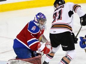 Calgary Hitmen Matteo Gennaro, right, tries to stop score on Edmonton Oil Kings goalie Patrick Dea in WHL action at the Scotiabank Saddledome in Calgary, Alberta, on Sunday, March 12, 2017. The Oil King will conclude their season with a home-and-home series against the Red Deer Rebels this weekend.