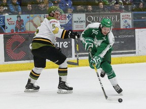 Ryan Valentini, right, of the Sudbury Wolves, slips by Jesse Saban, of the North Bay Battalion, during OHL action at the Sudbury Community Arena in Sudbury, Ont. on Friday March 17, 2017. John Lappa/Sudbury Star/Postmedia Network