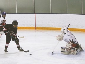 The Vulcan atom b Hawks goalie Caden Wouters defends his net during his team's third playoff game against the Kainai Young Braves Saturday morning at the Vulcan District Arena.