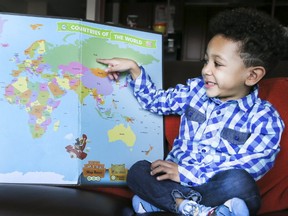 Isaiah McDonald ,4, a geography whiz kid, points to a world map and identifies the countries on Thursday March 16, 2017 in Scarborough. (Veronica Henri/Toronto Sun)