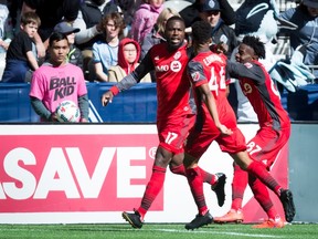 Toronto FC's Jozy Altidore, left to right, Raheem Edwards and Tosaint Ricketts celebrate Altidore's goal during second half MLS action against the Vancouver Whitecaps, in Vancouver on Saturday, March 18, 2017. THE CANADIAN PRESS/Darryl Dyck