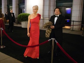 In this Thursday, Jan. 19, 2017 file photo, President-elect Donald Trump adviser Kellyanne Conway, centre, accompanied by her husband, George, speaks with members of the media as they arrive for a dinner at Union Station in Washington, the day before Trump's inauguration. (AP Photo/Matt Rourke)