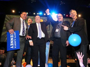 Jason Kenney raises arms with outgoing leader Ric McIver after winning the Alberta PC leadership in downtown Calgary on Saturday March 18, 2017. Gavin Young/Postmedia Network