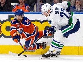 Edmonton Oilers forward Jordan Eberle battles for the puck with Vancouver  Canucks defenceman Alexander Edler at Rogers Place on Saturday, March 18, 2017.