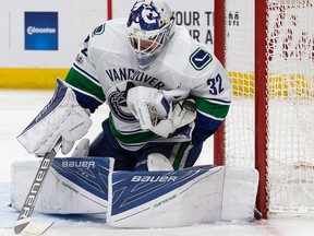 Vancouver Canucks' goalie Richard Bachman (32) makes a save against the Edmonton Oilers during second period NHL action at Rogers Place, in Edmonton Saturday, March 18, 2017.