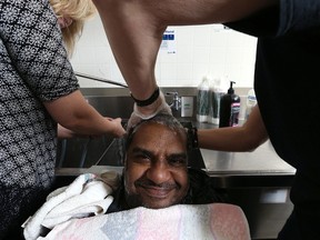 George Singh is all smiles as he has his hair washed during the Snippets of Love event at the Lighthouse Mission on Main Street in Winnipeg on Sun., March 19, 2017. The less fortunate were treated to a free haircut and style. Kevin King/Winnipeg Sun/Postmedia Network
