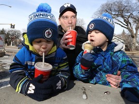 John Graumann and son Evan (left), 6, sip on milkshakes as Nolin, 3, works on his ice cream cone at the Bridge Drive-In on Jubilee Avenue in Winnipeg on Sun., March 19, 2017. Kevin King/Winnipeg Sun/Postmedia Network