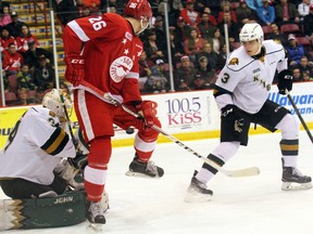 Screened London Knights goalie Tyler Johnson braces as the puck flies between Soo Greyhound winger Tim Gettinger?s legs as defender Nicolas Mattinen closes in in first-period OHL action at the Essar Centre in Sault Ste. Marie Sunday. The Knights? playoff picture firmed up Sunday as they were nipped 6-4 by the Hounds to finish fourth in the Western Conference and face Windsor in the first round starting Friday at Budweiser Gardens. (JEFFREY OUGLER, Postmedia News)