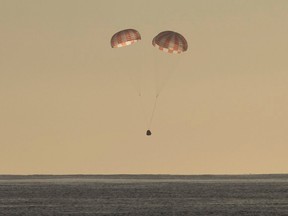 In this photo provided by SpaceX, the Dragon cargo ship parachutes into the Pacific off the Southern California coast on Sunday, March 19, 2017. Astronauts set it free from the International Space Station about 5½ hours earlier. (SpaceX via AP)