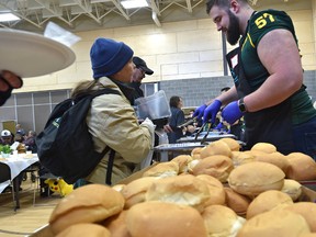 Eskimos offensive lineman, David Beard volunteered to serve up meals at the Inner City Roast Beef Dinner which provides approximately 1,200 hot roast beef meals to inner city residents each year at the Boyle Street Plaza in Edmonton, Sunday, March 19, 2017. Ed Kaiser/Postmedia