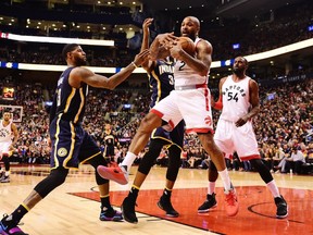 Toronto Raptors forward P.J. Tucker grabs a rebound in front of Indiana Pacers forward Paul George and Pacers centre Myles Turner as Raptors forward Patrick Patterson looks on during an NBA game on March 19, 2017. (THE CANADIAN PRESS/Frank Gunn)