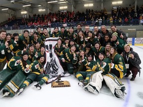 The University of Alberta Pandas pile onto the ice in Napanee, Ont., to pose with their newest banner after defeating the McGill University Martlets 2-1 in double-overtime of the U Sports women's national hockey championship, Sunday, March 19, 2017. (Supplied by Queen's University)