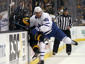 Toronto Maple Leafs defenceman Roman Polak (46) checks Boston Bruins center David Krejci into the bench during the second period of an NHL hockey game in Boston, Saturday, Feb. 4, 2017. (AP Photo/Mary Schwalm)