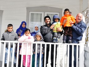 Members of the Al Mohamad family arrived in Mitchell from Lebanon, through Syria, on March 7 after more than a three-year wait to flee their war-torn country and life in safety in Canada. The family is thrilled to be in their new home in Mitchell, located on Ontario Road. Pictured last week with Louis DeDecker (right), West Perth Syrian Refugee Committee Chair, are Ibrahim (left), 10; mom Shamsa, Yasmin, 9; Karima, 10; Hussein, 7; dad Mohamad holding two-year-old son Hassan, and Abdullatif, 4. ANDY BADER/MITCHELL ADVOCATE