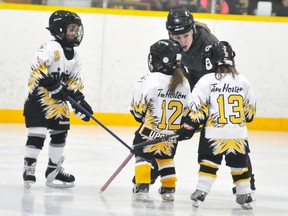 U7 Mitchell coach Erica Vosper gives some on-ice tips to Ryelyn Carnochan (9), Emma Upshall and Dani Vosper. ANDY BADER/MITCHELL ADVOCATE
