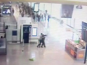 In this image taken from video of CCTV footage provided to AP on the condition that its source not be revealed, suspected Islamic extremist Ziyed Ben Belgacem, centre left, holds a soldier after grabbing her from behind at Paris’ Orly airport, Saturday, March 18, 2017. The Associated Press has obtained security footage of the Saturday attack, which caused panic and shut down the French capital’s second-biggest airport. Belgacem was shot dead within three minutes during a standoff with two other soldiers. (CCTV via Mobile Phone via AP)