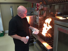 James Meadows, owner of Catering by James Meadows, heats things up at the Elgin Business Resource Centre Monday afternoon. The chef set up shop in the business incubator's industrial kitchen three years ago and hasn't looked back. Meadows is just one of the tenants to call the South Edgeware St. centre home as it celebrates 30 years in St. Thomas. (Jennifer Bieman/Times-Journal)