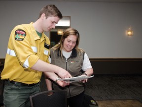 Josh Hoddinott shows Laura Stewart, president of FireSmart Canada, which plants are most fire resistant during the open house held at the Heritage Inn on March 15. | Caitlin Clow photo/Pincher Creek Echo